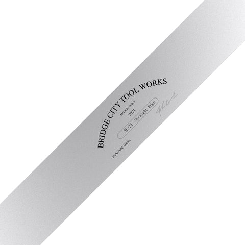 A close-up image of a 24 inch straight edge tool with a reflective silver surface and black text branding.