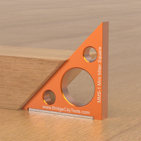 An orange Mini Miter Square tool made of aircraft grade aluminum alloy, used for measuring 90° and 45° bevel angles, with an adjustable sliding foot.