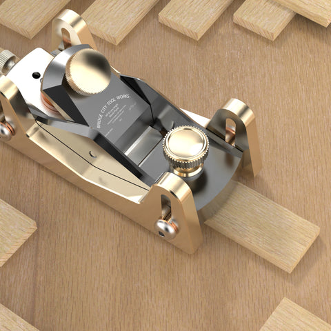 HP-8 Mini Block Plane with a silver-colored body, showing the side profile of the tool with its iron and sole visible, on wood piece