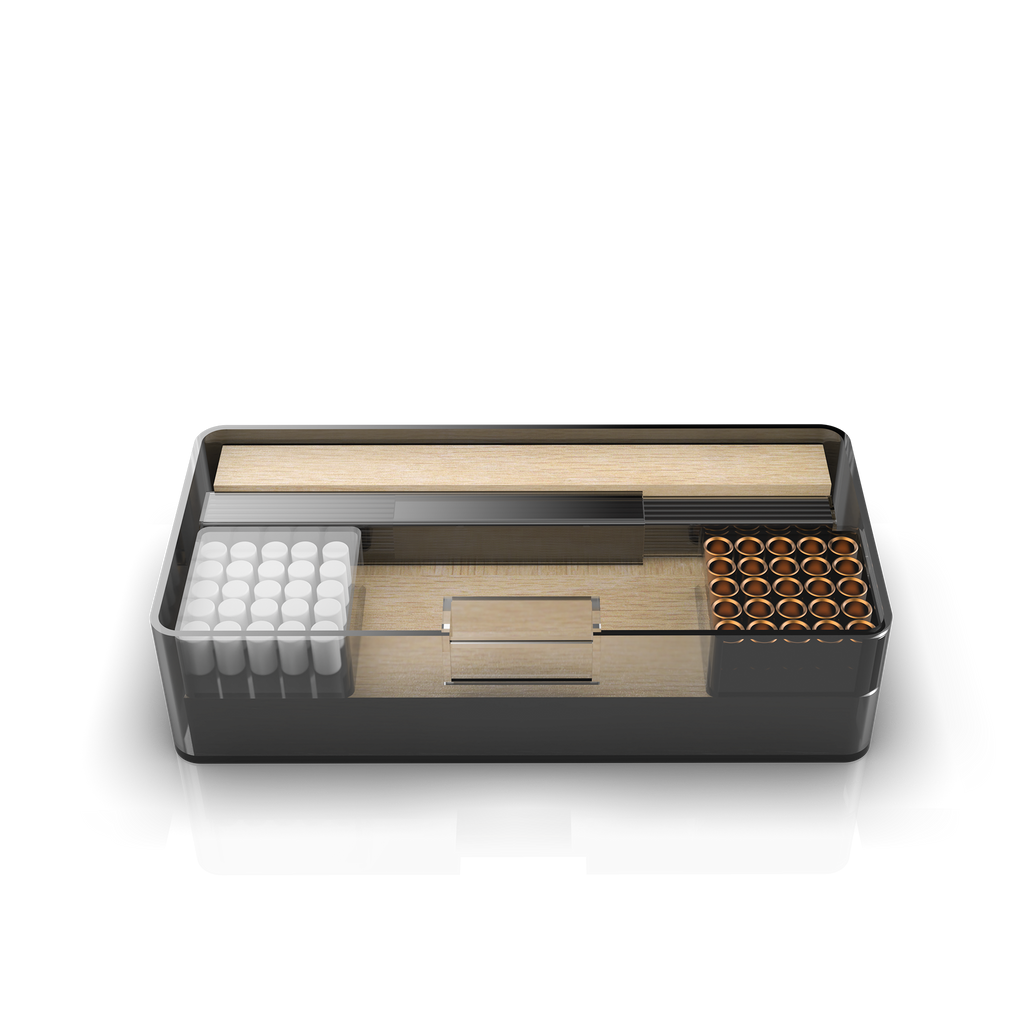A plastic box containing pencil leads, ferrules, erasers, and pencil blanks. The box is open, showing the contents arranged in compartments.